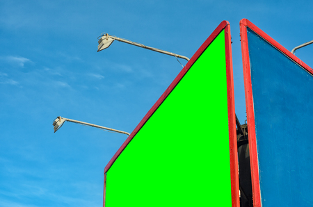 Blank billboard with Chroma key against blue sky. Red frame billboardの写真素材