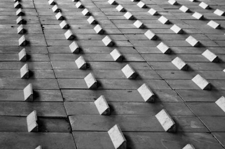 Black and white abstract geometrical pattern. Rhythmic pattern background from concrete blocksの写真素材