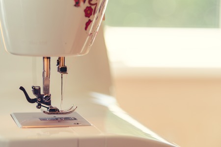 Close-up detail of the Full automatic sewing machine. Background of working placeの写真素材