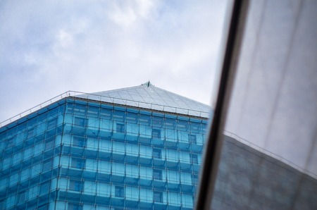 Modern building background. Glass facade in the reflection of the polished granite wallの写真素材