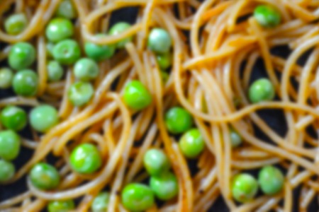 Food background. Pasta with green peas in during cookingの写真素材