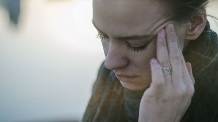 Young woman with sinus pressure pain. Depressing state conceptの写真素材