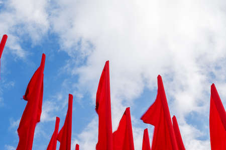 Group of red flags on blye sky backgroundの写真素材