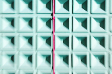 Abstract motion blur background of mint green concrete wall with square cells geometrical patternの写真素材