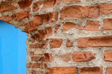 Red brick wall texture shattered by time. Grunge backgroundの写真素材