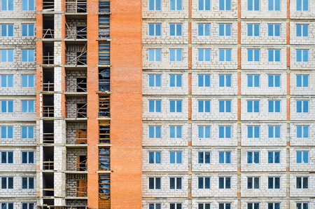 Facade of a multi-storey residential building under constructionの写真素材