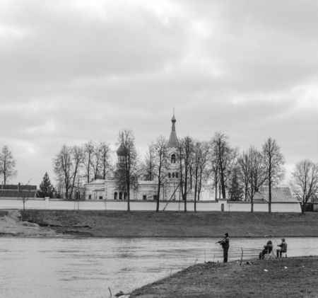 Three fishermen on the river bankの写真素材