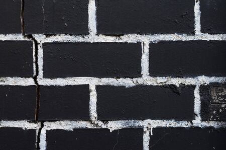 Rough brick wall texture painted in black with painting seams in white. Brickwork textureの写真素材