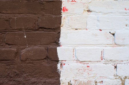 Multicolored old brick wall background. Black, white, brown and yellow mosonry textureの写真素材