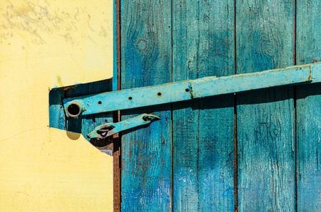 Yellow plastered facade with blue wooden doors. Yellow Wall Backgroundの写真素材