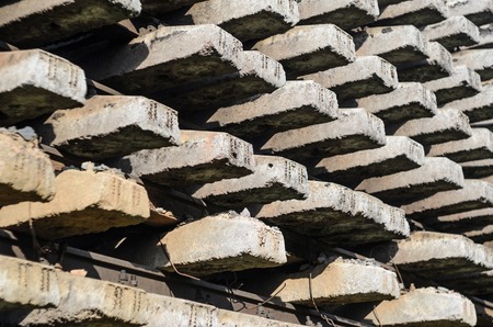 The rails and sleepers are stacked. Storage of railway infrastructure elements. Railway transport background.の写真素材