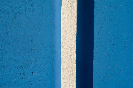 Blue plaster wall texture with white vertical stripe . Empty plaster backgroundの写真素材