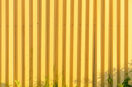 Yellow corrugated metal texture. Empty wall backgroundの写真素材
