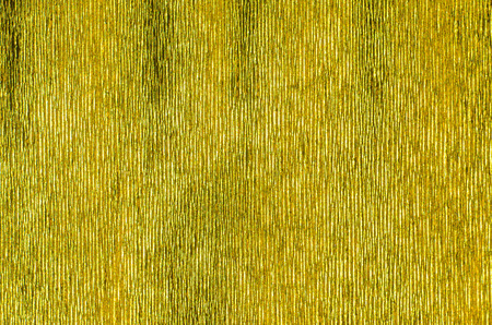 Gold Texture of Embossed Paper. Gold Paper Texture Background. Abstract background with deep grooves in the texture of corrugated paper. Pattern of vertical groovesの写真素材