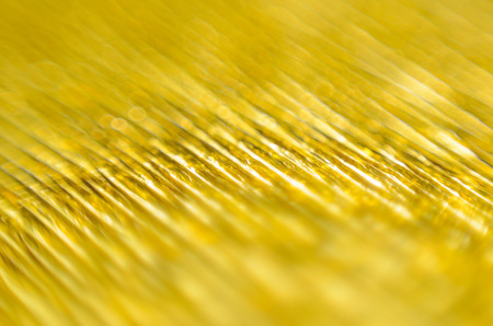 Gold Texture of Embossed Paper. Gold Paper Texture Background. Macro. Shallow depth of field. Abstract background with deep grooves in the texture of corrugated paperの写真素材