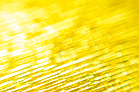 Gold Texture of Embossed Paper. Gold Paper Texture Background. Macro. Shallow depth of field. Abstract background with deep grooves in the texture of corrugated paperの写真素材