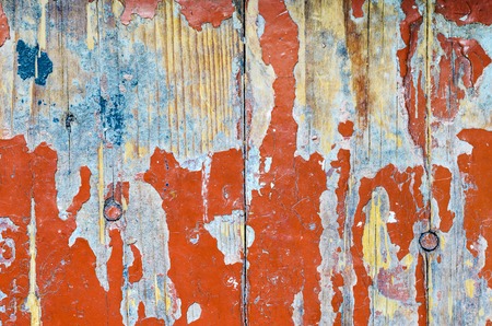 Texture of old dilapidated wooden floor with red peeling paint. Exfoliated Paint on an Old Wooden Floorの写真素材