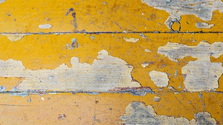 Texture of old dilapidated wooden floor with yellow peeling paint. Exfoliated Paint on an Old Wooden Floor. Shabby Backgroundの写真素材