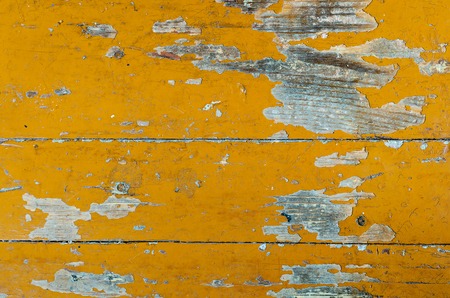 Texture of old dilapidated wooden floor with yellow peeling paint. Exfoliated Paint on an Old Wooden Floor. Shabby Backgroundの写真素材