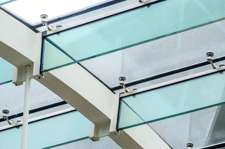 The Fastening of the Glass Roof to the Glass Beams. Structural Glass Roof in the Interior of a Modern Buildingの写真素材