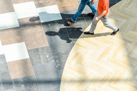 Silhouettes of Walking People in the Atrium of a Large Public Building, View from Above. Blur in Motion, Long Exposure. Abstract Backgroundの写真素材