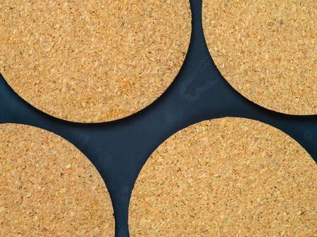 Cork drink coaster on dark blue backgroundの写真素材