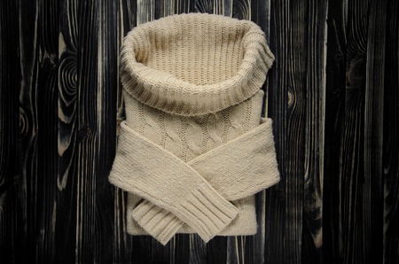 Sweater with a Large Throat on a Wooden Table, Top View. Kntt Clotges Backgroundの写真素材