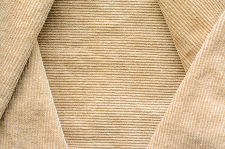 Texture of Beige Velvet Clothes. Geometric Pattern Neatly Stacked Textile Fabric of Corduroy as Blank Background for Your Designの写真素材