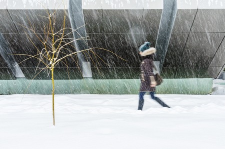 Silhouette of a late man. Hurry up in bad weather. Winter weather concept. Abstract blurred in motion backgroundの写真素材