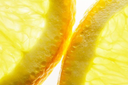 Orange Slices on White background. Shining Through. Macro Image of Ripe Orange for Background.の写真素材