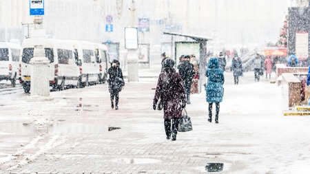 Blizzard in an Urban Environment. Crowd of Rushing People in Snowfall. Abstract Blurry Winter...