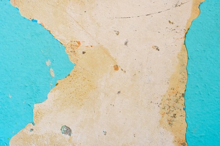 Peeling Blue Aquamarine Color Paint from the Wall. Shattered Plaster Background