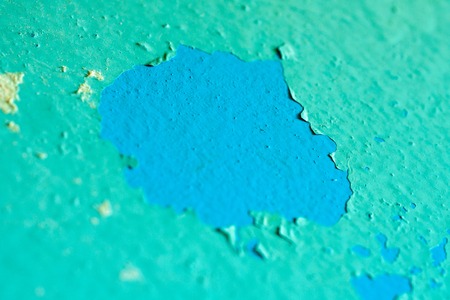Peeling Blue Aquamarine Color Paint from the Wall. Shattered Plaster Background