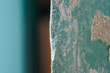 Peeling Blue Aquamarine Color Paint from Outer Corner of the Wall. Shattered Plaster Background....