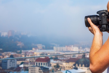 Traveler Young Man Photographs Attractions and Panorama of the Ancient City from a High Observation...
