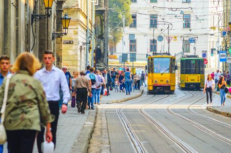 Lviv, Ukraine- September 1, 2018: Street of Old Tourist Town with Yellow Tramのeditorial素材