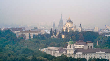 Lviv, Ukraine- September 1, 2018: Foggy Morning of the City Center from Town Hall Tower. Tiled Roofs of the Old City. View on Church of Sts. Olha and Elizabeth and building of st. George's Cathedralのeditorial素材
