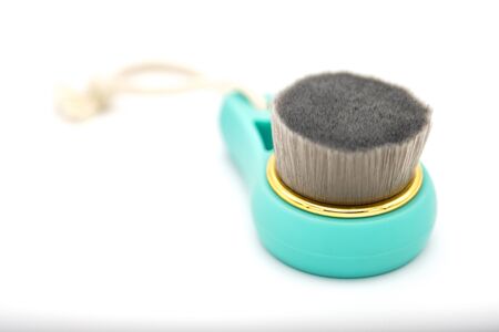 Brush for deeply clean and face wash, on white background. Face spa concept, beauty blog. Copy space