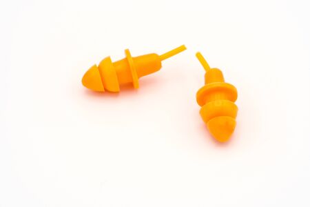 Orange earplugs on white background. Protection noise. Safety. Copy spaceの写真素材