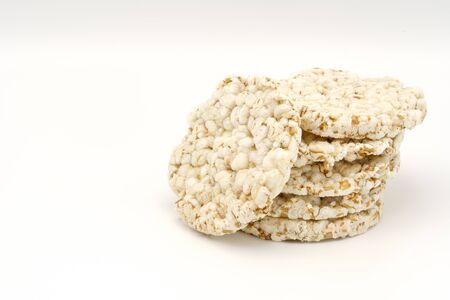 Grain crispbreads on white background. Puffed whole grain crispbread. Dieting Eating Concept. Copy spaceの写真素材