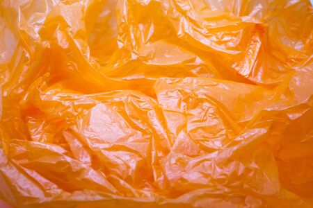 Orange Color Plastic Bag Texture. Abstract Wrinkled Background of Plastic Garbageの写真素材
