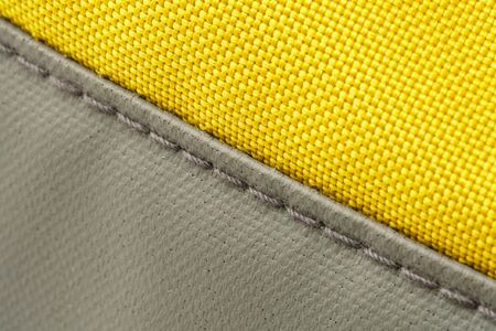 Seam on Durable Fabric of Yellow Sport Bag Close-Up. Yellow Nylon Backpack Backgroundの写真素材