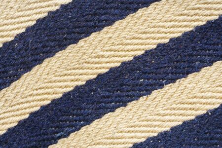 Herringbone tweed background with close up on fabric texture. Striped blue and white material