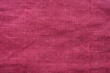 Red linen cloth texture. Natural fabric material backgroundの写真素材