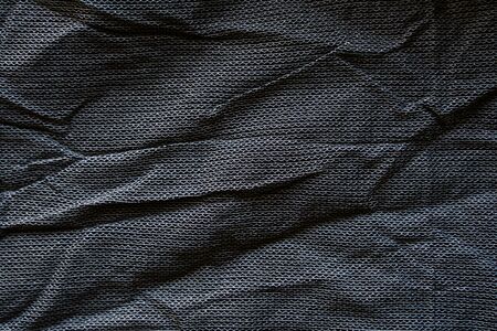 Crumpled black fabric texture. Clothing materials backgroundの写真素材