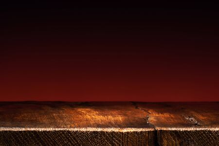 Empty Wooden Table on Dark Red Background. Backdrop for Product Placementの写真素材