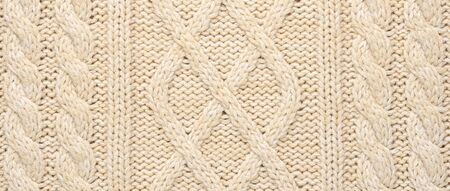 Beige Knitwear Fabric Texture with Pigtails. Beige Knitted Background.