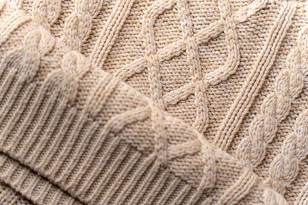 Beige Knitwear Fabric Texture with Pigtails. Beige Knitted Background.