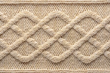 Beige Knitwear Fabric Texture with Pigtails. Beige Knitted Background.