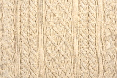 Beige Knitwear Fabric Texture with Pigtails. Beige Knitted Background.